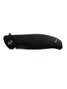 A folding pocket knife with a textured black handle and a dark metallic blade, shown on a light gray fabric background.